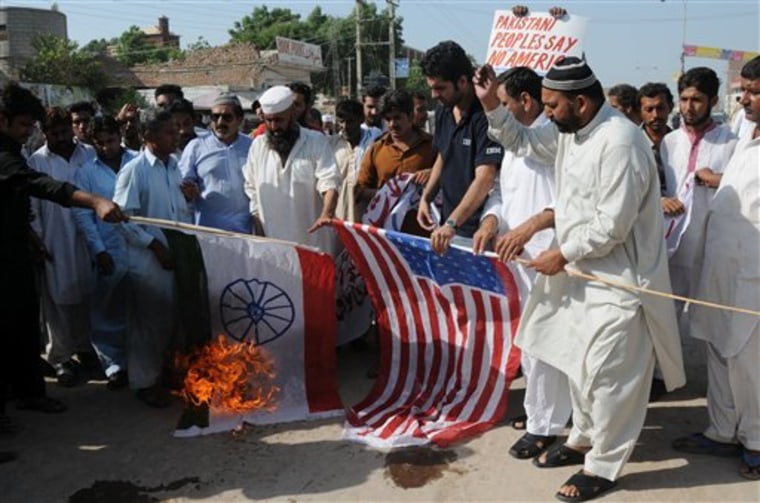 Pakistani protesters burn representations of US and Indian flags at an anti-American rally in Multan, Pakistan on Friday, Sept 23. Pakistan lashed out at the U.S. for accusing the country's most powerful intelligence agency of supporting extremist attacks against American targets in Afghanistan — the most serious allegations against Islamabad since the beginning of the Afghan war. 
